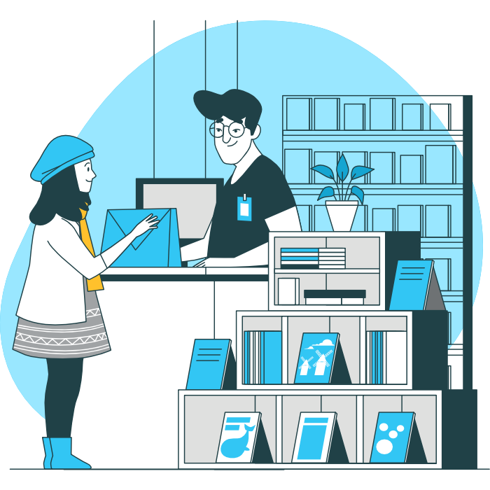 A woman checking out in a book store with a man working the register